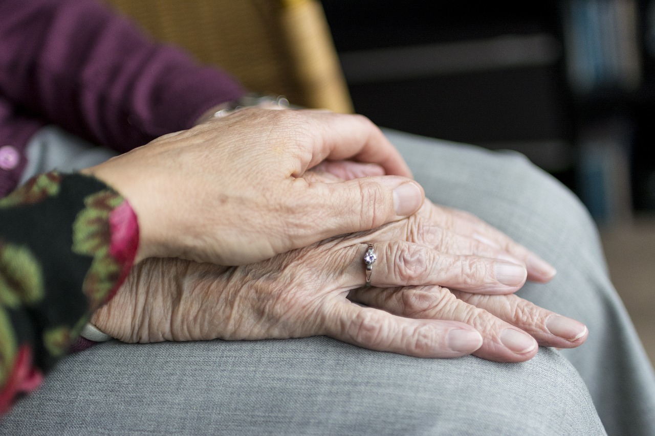 carers hands on residents hand