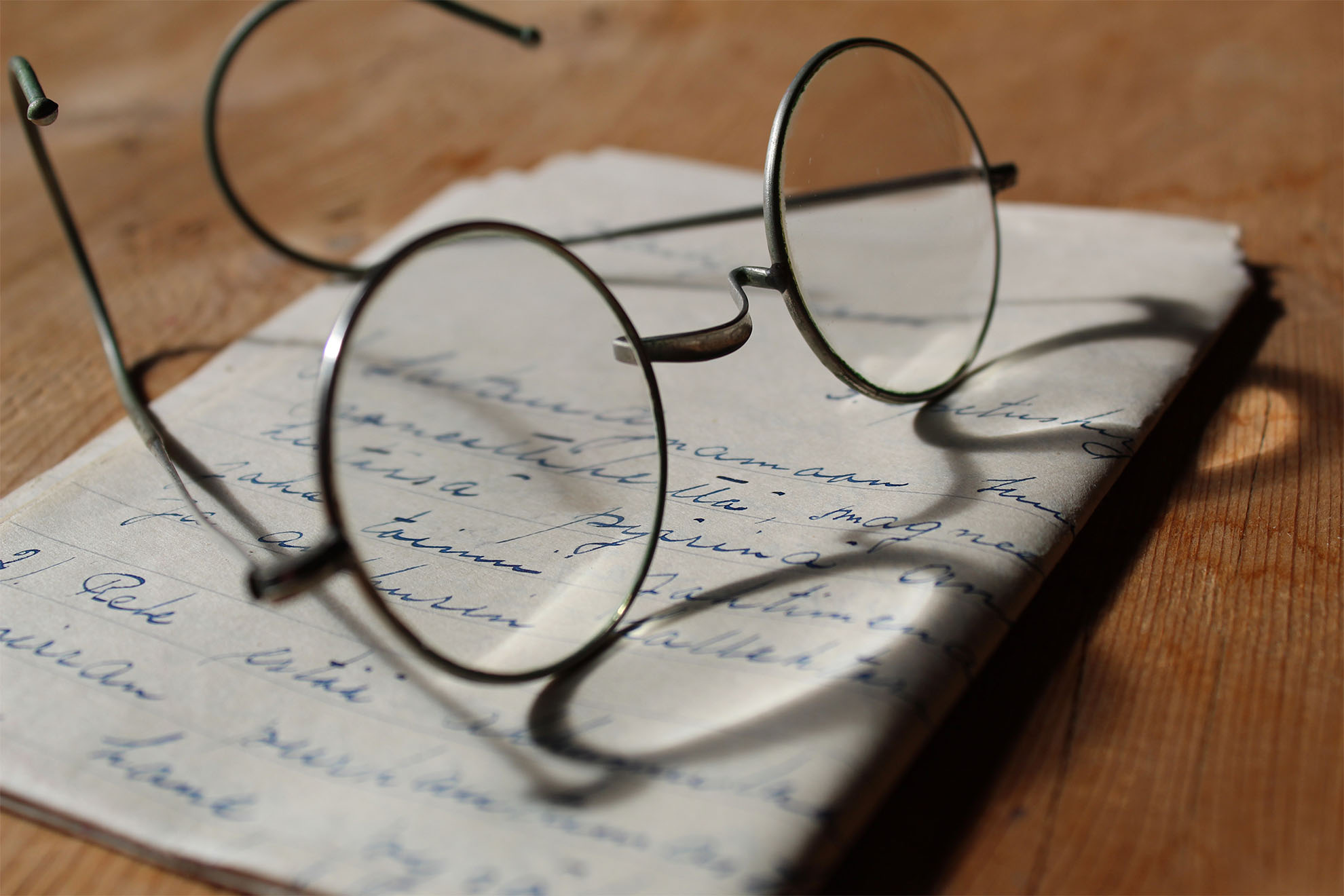 old glasses on written letter